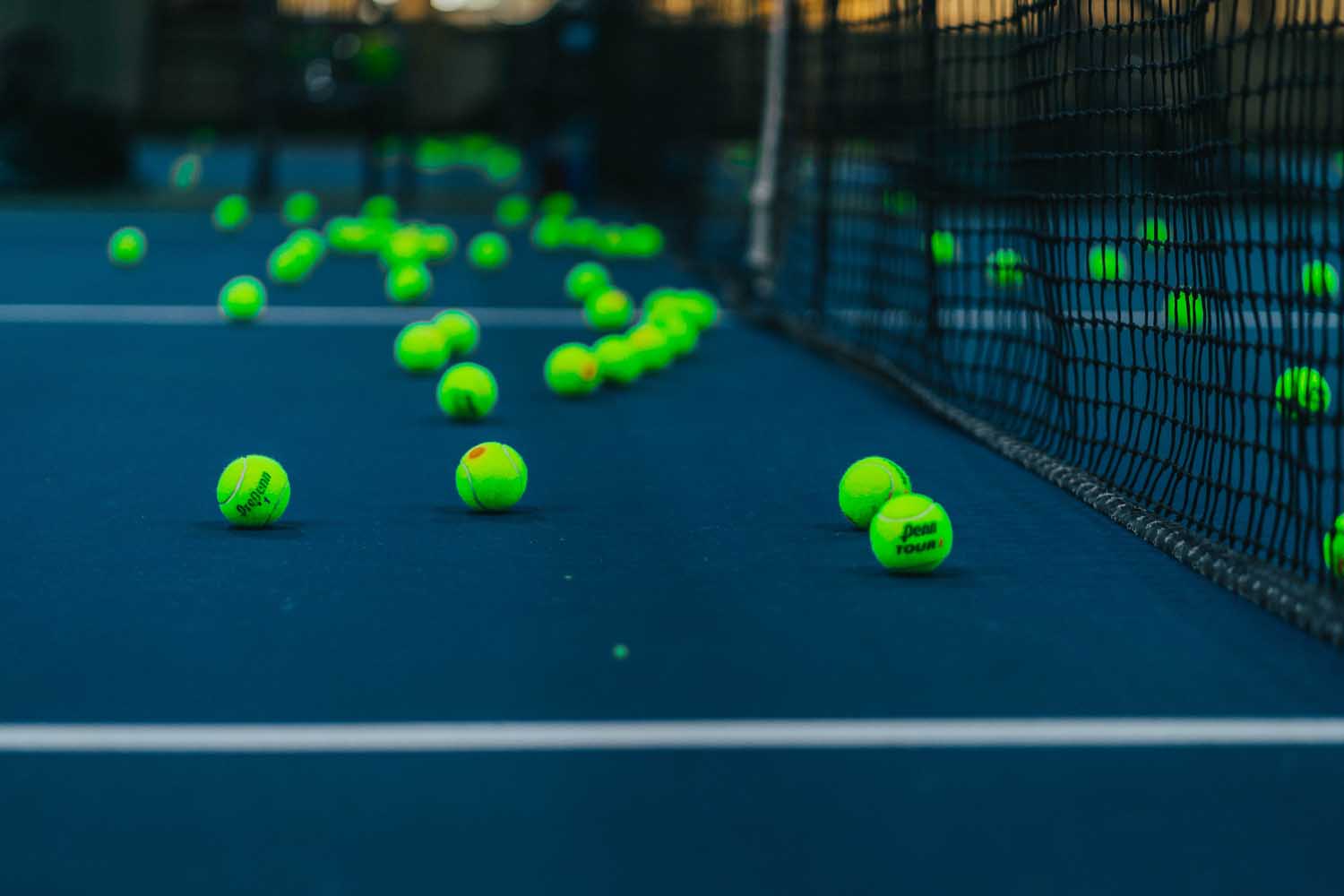 Tennis balls scattered on court at Karin Boshoff School of Tennis